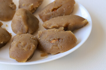 Turkish famous traditional homemade flour halva served with walnut in plate on rustic background, turkish dessert for holy night or funeral
