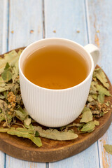 Winter herbal tea on a blue wood background. Winter tea. immune-boosting herbal tea. Medicinal tea prepared from linden leaves, Clove particles and Chamomile