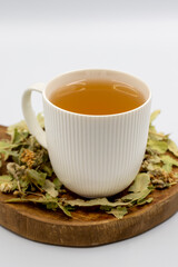 Winter Herbal tea isolated on a white background. Linden tea. immune-boosting herbal tea. Medicinal tea prepared from linden leaves, Clove particles and Chamomile.