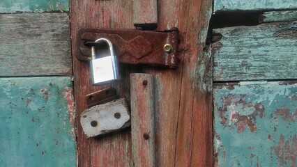 old door lock by padlock in urban area