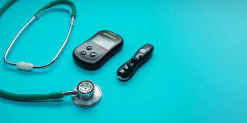 Glucose meter, pen, stethoscope. Diabetes concept. World diabetes day. Copy space.