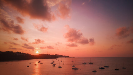 Marinas in the bay have many sailboats at sea with beautiful sunrise tropics in Phuket, Thailand.