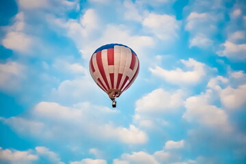 Balloon on the background of blue sky with white clouds in summer