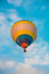 Balloon on the background of blue sky with white clouds in summer