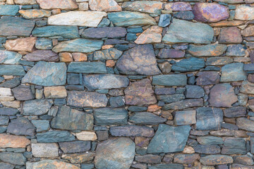 Stone Wall. Wallpaper Background. Isolated.Stone wall with mixed size stones and different shapes. Stock Image.