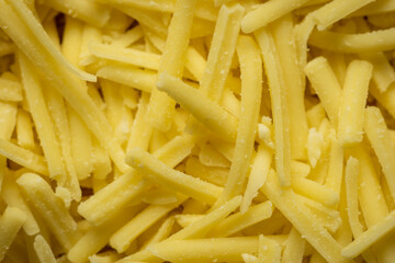 grated cheddar cheese background closeup