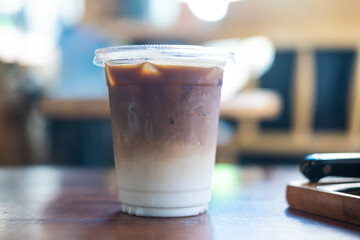 Iced latte coffee in a plastic glass 16 oz.