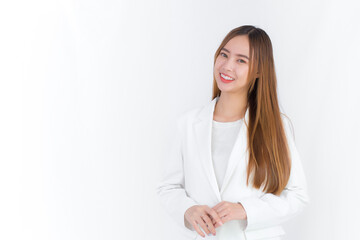 Beautiful business professional Asian woman with long hair wears white suit and shirt which she smiles and stands look at the camera isolated on white background.
