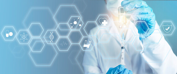 A doctor in a white coat draws medicine into a syringe from an ampoule. Doctor in blue protective, medical gloves works. Medical background with doctor, copy space, polygons for icons or information