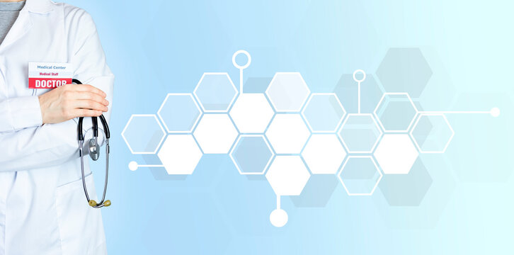 Doctor in a white coat with a badge and a stethoscope in his hand. Copy space with geometric empty polygons for icons. Doctor on a blue background.