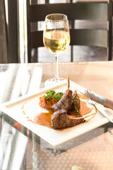 Grilled lamb and glass of wine at restaurant. Hot Meat Dishes