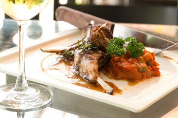 Grilled lamb and glass of wine at restaurant. Hot Meat Dishes