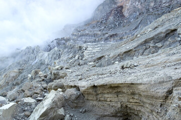 Beautiful natural volcanic landscape with hardened lava cracks and fumes or water vapor