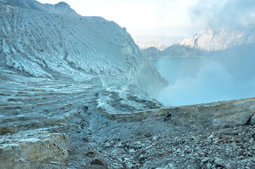 Beautiful natural volcanic landscape with hardened lava cracks and fumes or water vapor