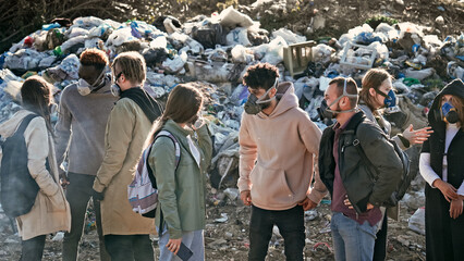 Group of Young Volunteers in Gas Masks Take Care of the Environment While Standing. Responsibility by the Future Ecology.Activists Discuss About Worldwide Global Problem of Pollution of Planet.