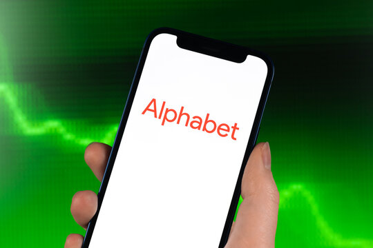 Alphabet Inc logo, stock trade on green chart. Google company, technology industry. Finance market background photo