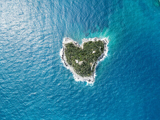 Aerial view of Bergeggi island, heart island from above, in Liguria, north Italy. Drone photography of the Ligurian coast, province of Savona with Spotorno and the island of Bergeggi.