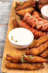 set of snacks: sausages, nuggets, cheese sticks, toast, cabbage salad. Side view, selective focus.