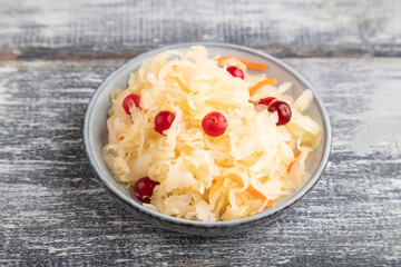 sauerkraut, marinated cabbage on a gray wooden background. Side view, close up.