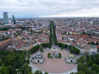 Fototapeta na wymiar Aerial view of Arco della Pace in Milano, north Italy. Drone photography of Arch of Peace in Piazza Sempione, near Sempione park in the heart of Milan, Lombardy and Sforza Castle.