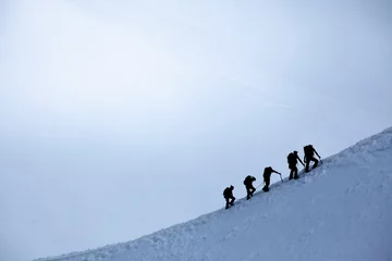 Papier Peint photo Mont Blanc silhouette of group of climbers reaching the summit