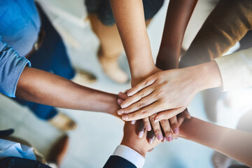 Together we can do great things. Cropped shot of a group of businesspeople piling their hands on...