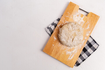 Flour and soft bread dough in bakery, background with copy space for text. Flat lay