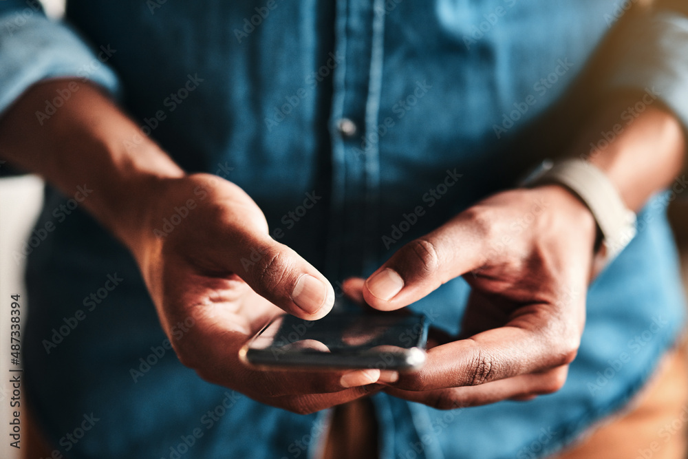 Poster My customers can text me too. Cropped shot of an unrecognizable businessman standing alone in his home office and texting on his cellphone.