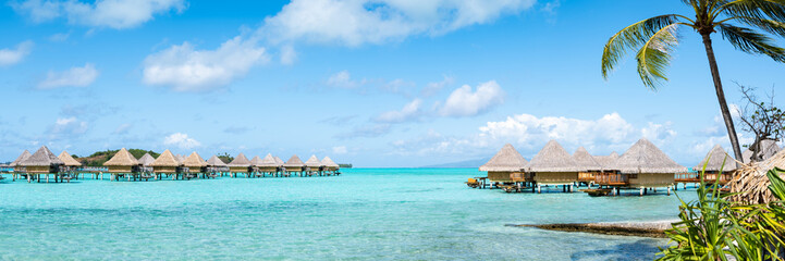 Summer vacation in an overwater bungalow at a luxury beach resort - obrazy, fototapety, plakaty