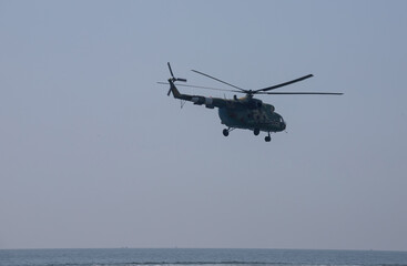 Fototapeta premium The military helicopter against the blue sky
