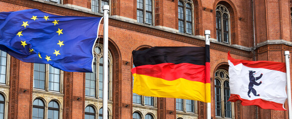 a european, a german and the flag of berlin germany in the wind panorama © Tobias Arhelger