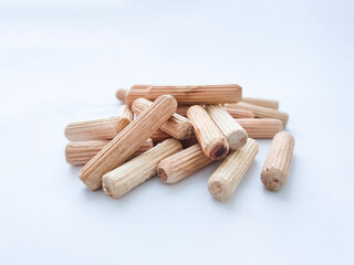 Wooden dowels for assembling furniture on white background. Front view