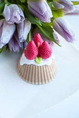 romantic handmade candle made of natural soy wax in the form of strawberry cake 