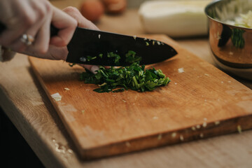Mom cooks dinner, cuts greens