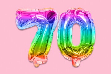 Rainbow foil balloon number, digit seventy on a pink background. Birthday greeting card with inscription 70. Anniversary concept. Top view. Numerical digit. Celebration event, template.