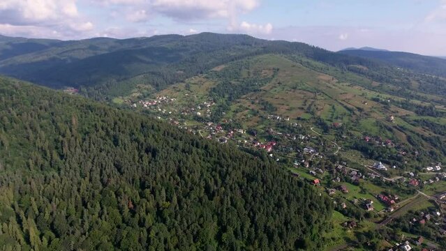 Beautiful aerial shot of a small town in the mountains in summer on a bright sunny day