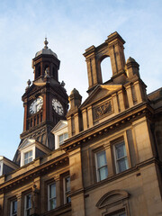 Fototapeta na wymiar close up of the the old post office in leeds city square in west yorkshire against a blue sky