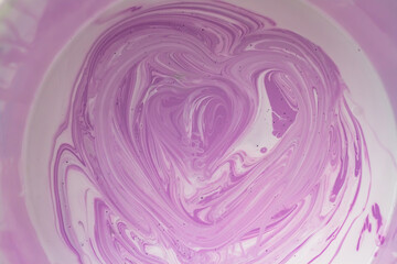 Streaks of purple and white paint when mixing different colors to get a shade. Background