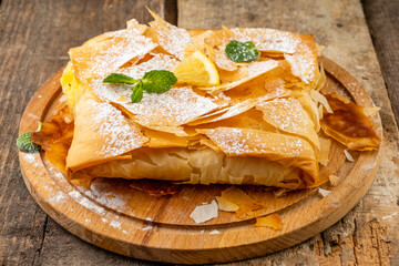 Bougatsa baked from filo dough with a sweet filling. Greek cuisine.