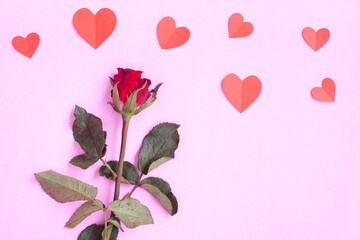 Red heart papercut and red rose on pink background