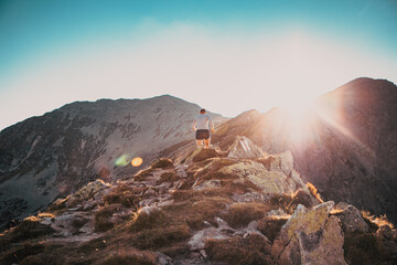trail runner running in mountain landscape at sunset active lifestyle