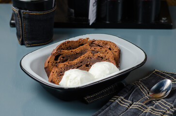 Chocolate cake with ice cream. Dessert in an enamel bowl