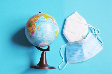 Globe, mask and respirator photography. End of the global coronavirus pandemic concept