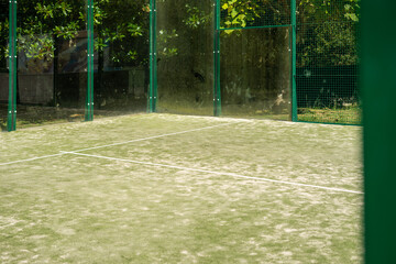 Empty paddle tennis court with sand