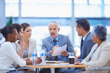 Taking a look at the costs and benefits. A cropped shot of a diverse group of businesspeople having a meeting.