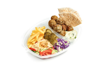 Menu combo - hummus with vegetable salad, French fries, pita and falafel in a plastic bowl on a white background