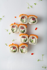 Asian food sushi with tuna fish and avocado on light surface top view
