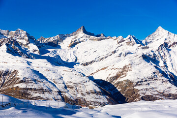 View of the picturesque mountain peaks in winter, located near the popular resort of Zermatt, Switzerland
