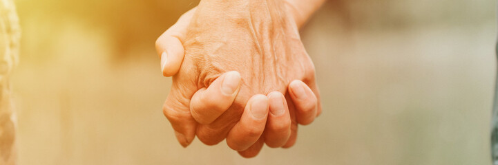 happy senior couple holding hands. hands of man and woman hold each other. romance and love and...