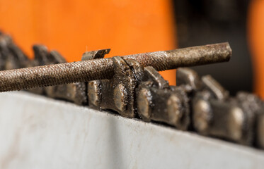 Chainsaw chain sharpening with file. Closeup macro shot